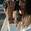 Anne holding her camera with the ash cuff on her wrist