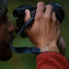 Alving holding his camera with a midnight cuff on his wrist