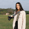Anne holding her camera with the ash slide around her body wearing it as sling