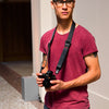 Alvin wearing the black Slide Lite with his camera around his neck