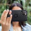 (image), Maria holding her Iphone 13 Pro max horizontally using its Everyday case finger loop, M-LC-BH-CH-1