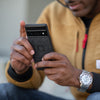 Alvin holding his Google Pixel Pro, hover-img