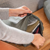 Opening the Medium Sage Packing cube using handles