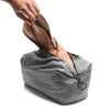Alvin putting his leather boots inside the shoe pouch