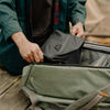 Packing the black variant of ultralight packing cube inside a bag