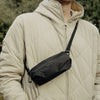 A guy wearing the double extra small ultra light packing cube